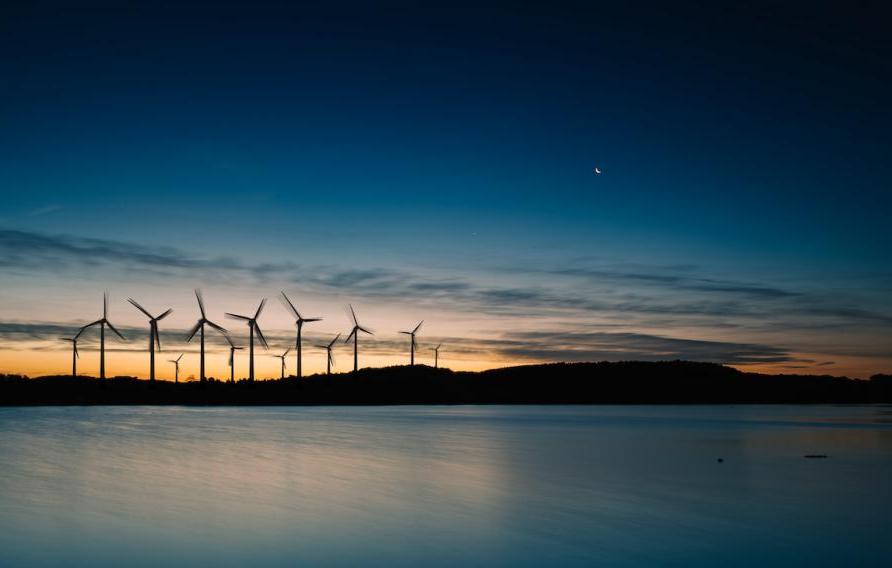 Wind turbines over water at night